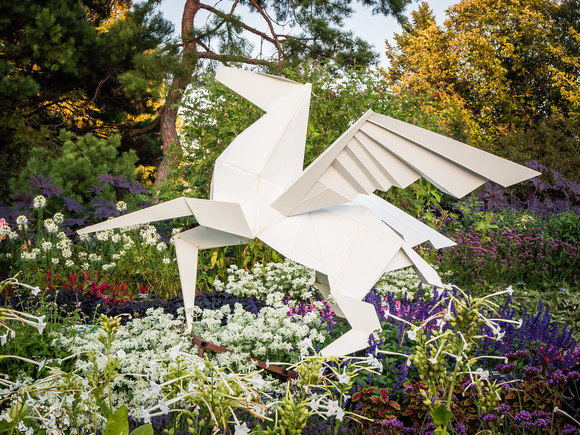 Hero's Horse Origami Sculpture among summer flowers in Annual Ga